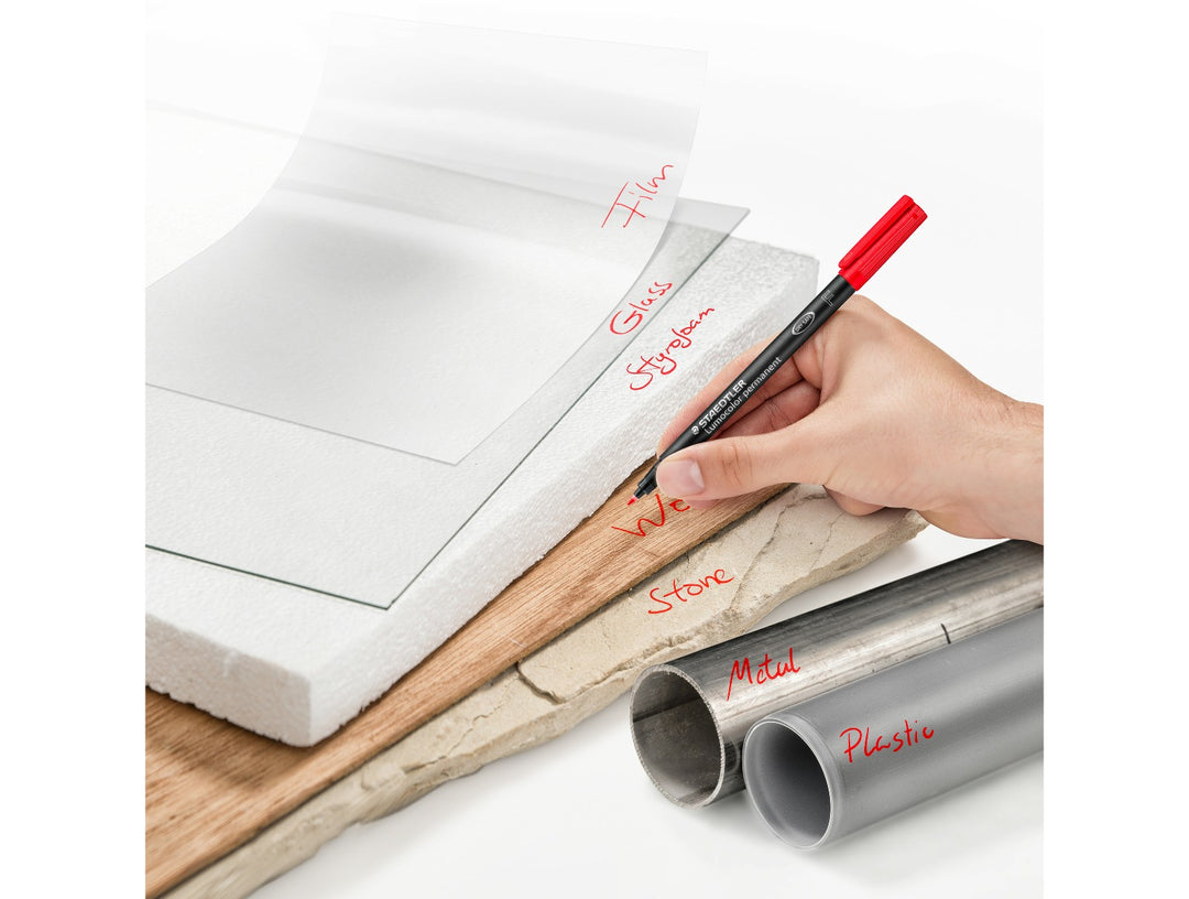 STAEDTLER Lumocolor permanent pen 318 fine 0.6 mm used for multi surface marking showing controlled red writing on various materials