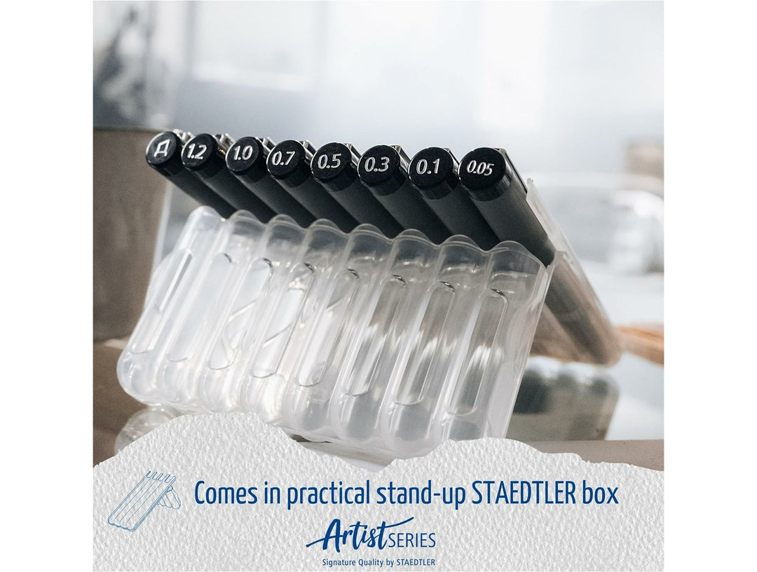 STAEDTLER pigment liner 308 black set of 8 in stand-up plastic case showing assorted line widths on desk