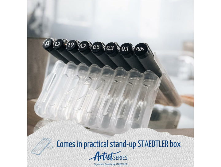 STAEDTLER pigment liner 308 black set of 8 in stand-up plastic case showing assorted line widths on desk