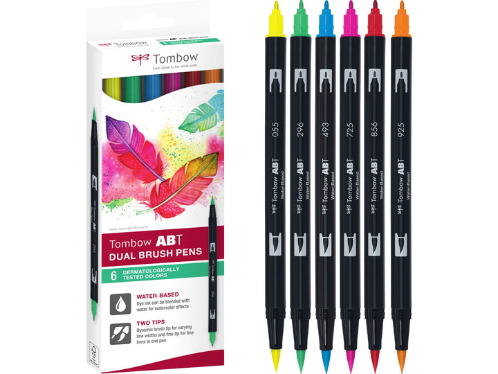 Tombow ABT Dual Brush Pen Dermatologically Tested Colours Set of 6 featuring Process Yellow (055), Green (296), Reflex Blue (493), Rhodamine Red (725), Poppy Red (856) and Scarlet (925), displayed alongside the original retail packaging with dual brush and fine tips for hand lettering, colouring, journaling, illustration and creative projects.