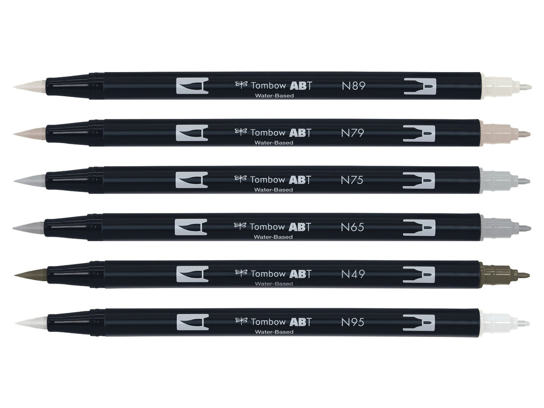 Tombow ABT Dual Brush Pen Grey Colours Set of 6 displayed individually, featuring Warm Grey 1 (N89), Warm Grey 2 (N79), Cool Grey 3 (N75), Cool Grey 5 (N65), Warm Grey 8 (N49) and Cool Grey 8 (N95), each with dual brush and fine tips visible for sketching, shading, hand lettering, illustration and monochrome artwork.