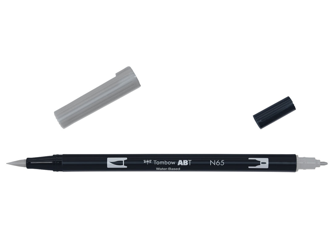 Tombow ABT Dual Brush Pen in Cool Grey 5 (N65) displayed with both caps removed, showing the flexible brush tip and fine bullet tip for sketching, shading, hand lettering, illustration and monochrome artwork.