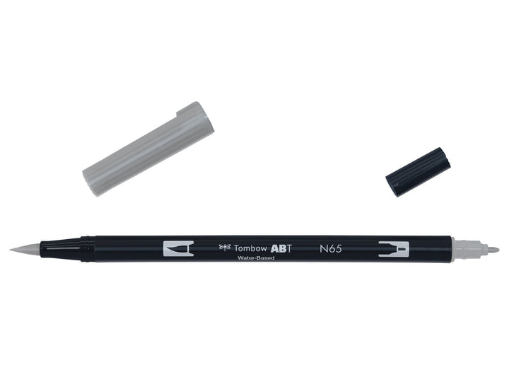 Tombow ABT Dual Brush Pen in Cool Grey 5 (N65) displayed with both caps removed, showing the flexible brush tip and fine bullet tip for sketching, shading, hand lettering, illustration and monochrome artwork.