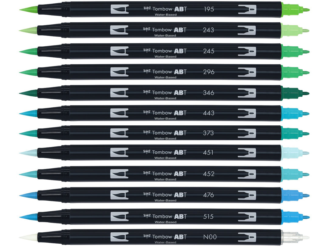 Tombow ABT Dual Brush Pen Ocean Colours Set of 12 displayed individually, featuring Light Green, Mint, Sap Green, Green, Sea Green, Turquoise, Sea Blue, Sky Blue, Process Blue, Cyan and Light Blue shades plus a colourless blender pen, each with dual brush and fine tips visible.