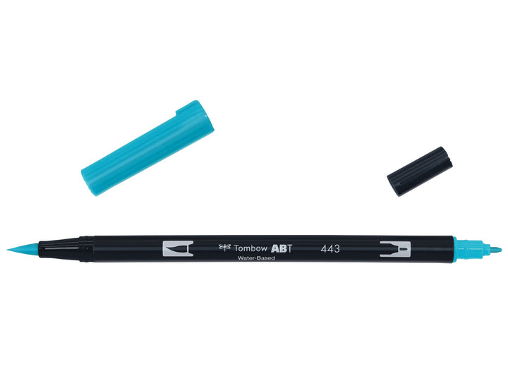 Tombow ABT Dual Brush Pen in Turquoise (443) displayed with both caps removed, showing the flexible brush tip and fine bullet tip for hand lettering, illustration, colouring and watercolour-style effects.