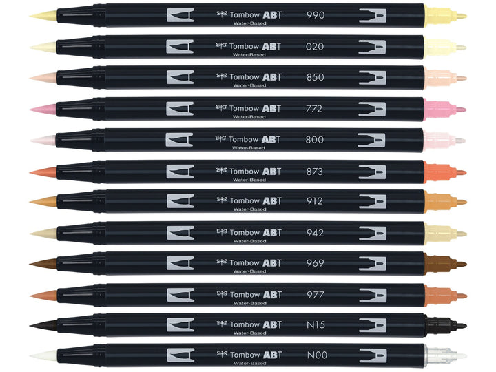 Tombow ABT Dual Brush Pen Skin Tones Set of 12 displayed individually, featuring Light Sand (990), Peach (020), Flesh (850), Blush (772), Baby Pink (800), Coral (873), Pale Cherry (912), Tan (942), Chocolate (969), Saddle Brown (977), Black (N15) and Blender (N00), each with dual brush and fine tips visible for portrait illustration, colouring and creative artwork.