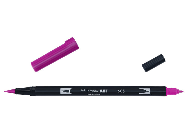 Tombow ABT Dual Brush Pen in Deep Magenta (685) displayed with both caps removed, showing the flexible brush tip and fine bullet tip for hand lettering, illustration, colouring and watercolour-style effects.