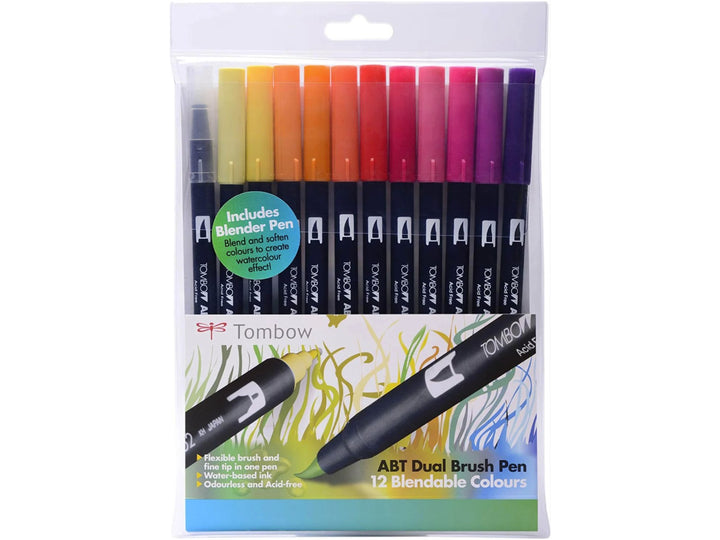 Tombow ABT Dual Brush Pen Sunset Colours Set of 12 featuring Pale Yellow (062), Light Orange (025), Gold Ochre (946), Orange (933), Red (905), Carmine (845), Cherry (815), Rhodamine Red (725), Hot Pink (743), Deep Magenta (685), Imperial Purple (636), Violet (606) and a colourless Blender (N00), with dual brush and fine tips for hand lettering, illustration, colouring and creative projects.