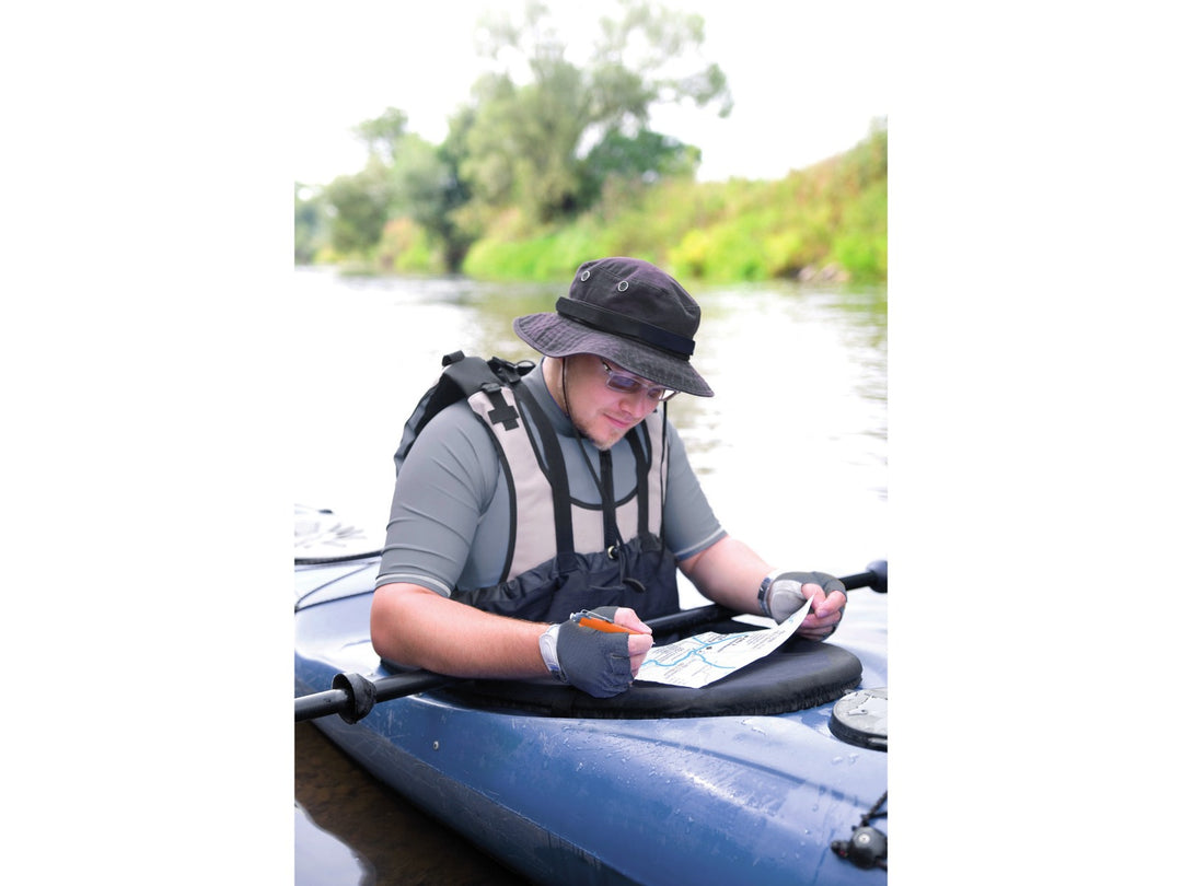 Tombow AirPress ballpoint pen being used during outdoor navigation from a kayak, demonstrating reliable writing performance in wet and challenging conditions