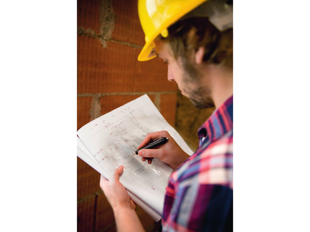 Tombow AirPress ballpoint pen being used for construction plans and site documentation, demonstrating reliable writing performance for professional and outdoor applications