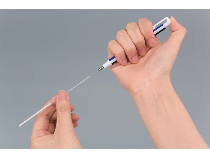 Tombow MONO Zero precision eraser refill replacement process showing a round eraser refill being inserted into the pen-style barrel using the push-button mechanism