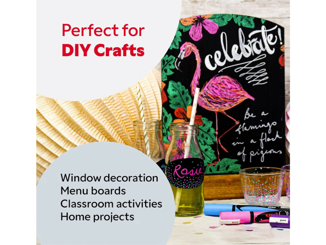 Lifestyle image showing a decorated chalkboard sign featuring a pink flamingo illustration and hand-lettered artwork created with uni ChalkGlass markers, displayed alongside painted glass bottles, decorative drinking glasses and assorted fluorescent chalk markers, demonstrating creative DIY crafts, window decorations, menu boards, classroom activities and home projects on non-porous surfaces.