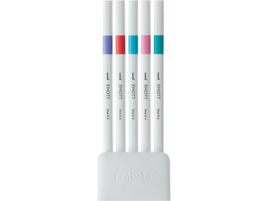 uni EMOTT Candy Pop Fineliners Set of 5 displayed in a white desk stand, featuring Light Blue, Coral Pink, Light Violet, Light Pink and Emerald Green fineliners with minimalist matte white barrels, durable 0.4mm tips and water-resistant fade-proof ink for journaling, note-taking, colour coding and creative projects.