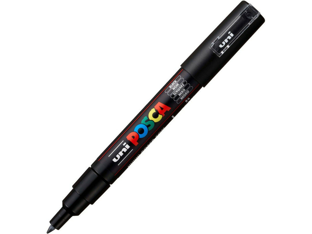 Black uni POSCA PC-1M extra fine water-based paint marker shown diagonally with cap removed, featuring a precision 0.7mm bullet tip for detailing, lettering and creative artwork