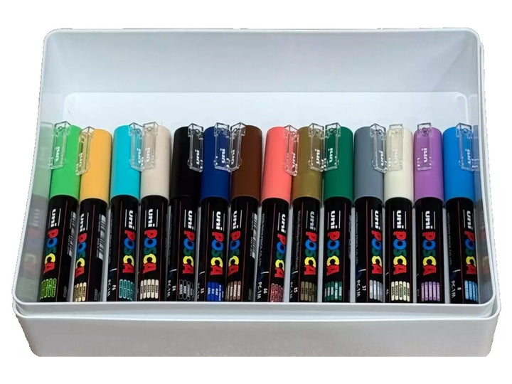 Open white storage box containing assorted uni POSCA PC-1M Extra Fine Paint Markers arranged in colour order, featuring vibrant and metallic shades including green, aqua, blue, pink, orange, red, grey, yellow, violet and white, with ultra-fine 0.7mm tips and opaque water-based pigment paint for illustration, outlining, hand lettering, model detailing, card making and creative projects on multiple surfaces.