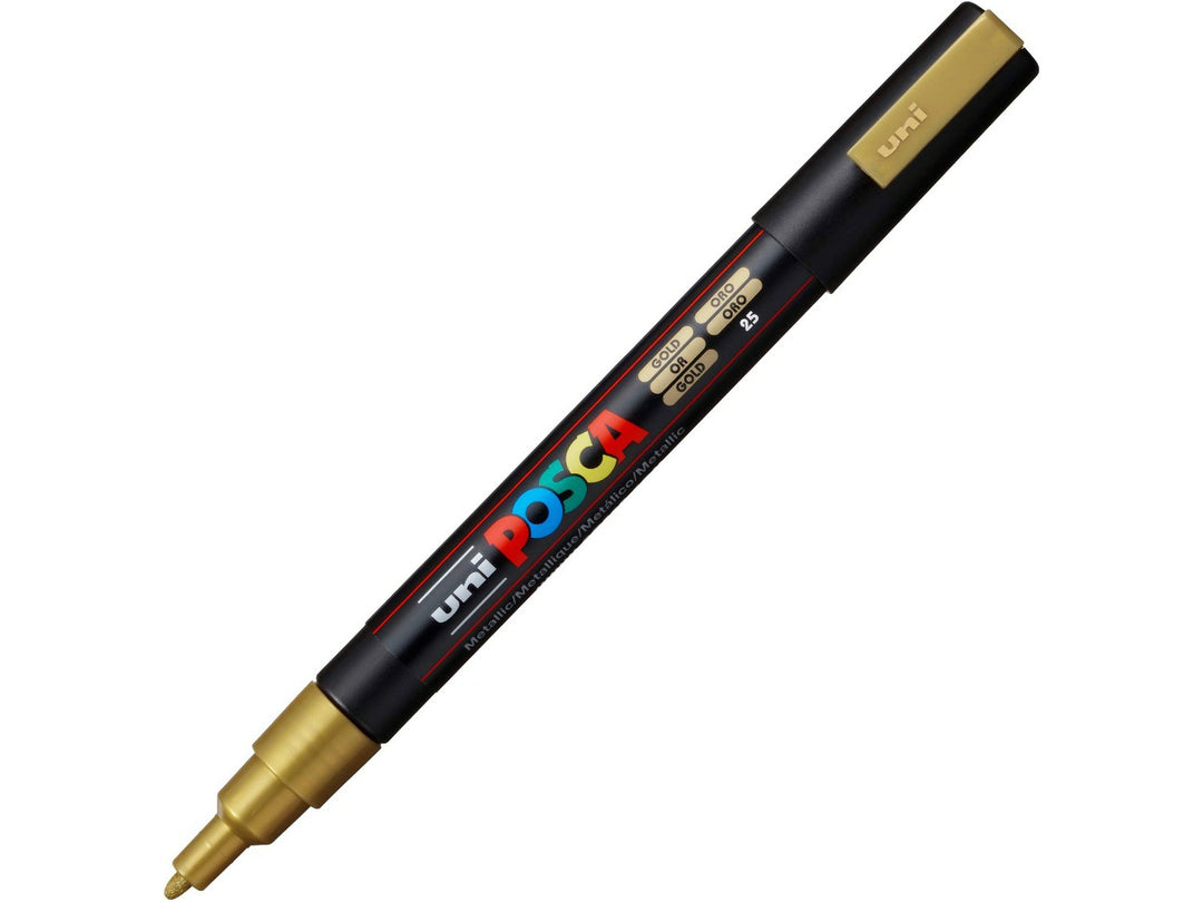 Gold uni POSCA PC-3M fine water-based paint marker shown diagonally with cap removed, featuring a metallic gold pigment ink and 0.9–1.3mm bullet tip for lettering, illustration and creative projects