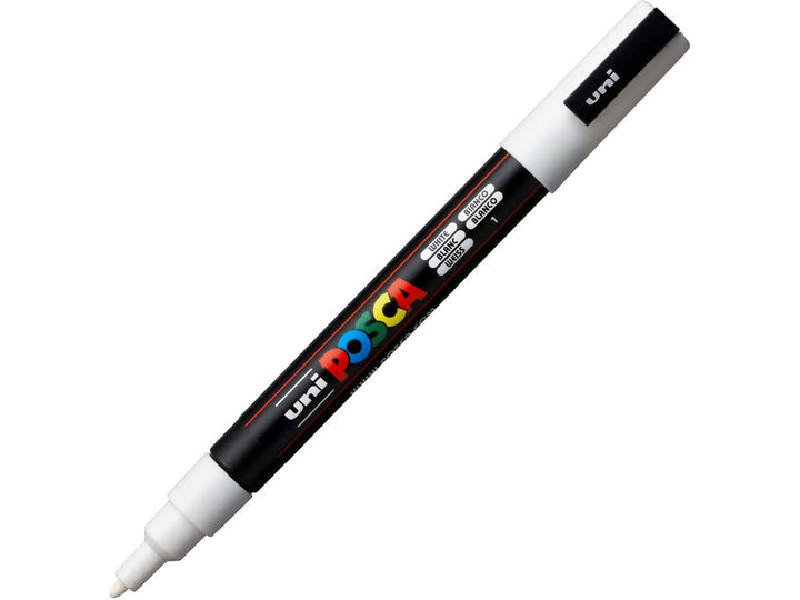 White uni POSCA PC-3M fine water-based paint marker shown diagonally with cap attached, featuring a 0.9–1.3mm bullet tip for lettering, illustration and creative projects