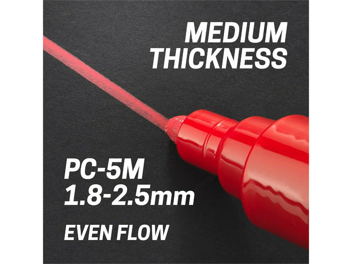 uni POSCA PC-5M medium bullet tip applying a 1.8–2.5mm line on a black surface, demonstrating even paint flow and medium line thickness
