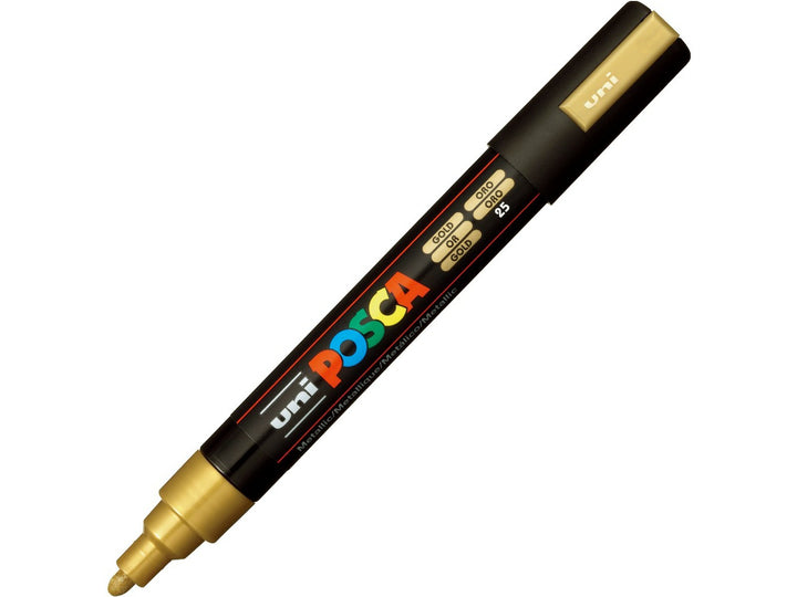 Gold uni POSCA PC-5M medium water-based paint marker shown diagonally with cap removed, featuring a metallic gold pigment ink and 1.8–2.5mm bullet tip for lettering, illustration, signage and creative projects