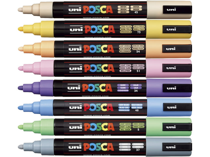 Eight uni POSCA PC-5M pastel paint markers arranged flat and uncapped in Beige, Straw Yellow, Light Orange, Light Pink, Lilac, Sky Blue, Light Green and Grey