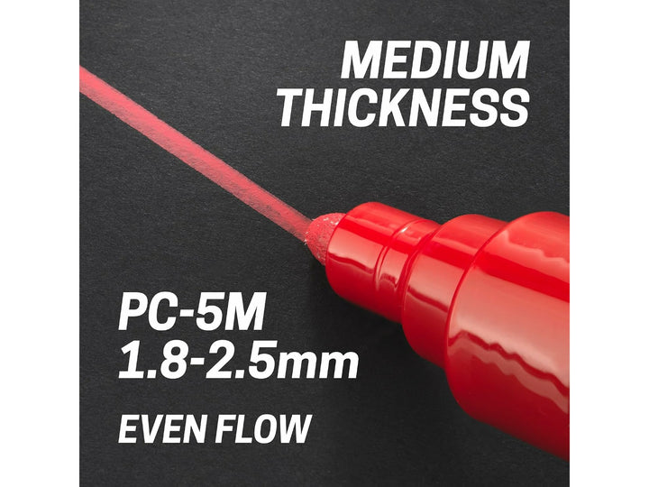 uni POSCA PC-5M medium bullet tip applying a red 1.8–2.5mm line on a black surface, demonstrating even paint flow and medium line thickness